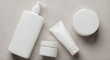 © Segi Empat Studio - A bunch of white beauty products sits on a texture marmer surface