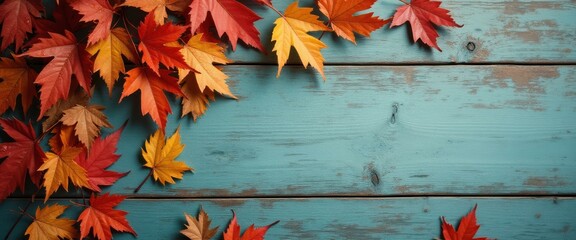 Autumn maple leaves on blue wooden background showcase fall colors and textures for seasonal themes.