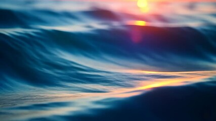 Wall Mural - Deep blue sea waves reflecting the golden sunset on a calm evening