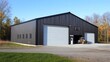 © gentho - Modern black metal building with large garage doors