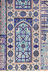  Vertical background with detail of ancient mosaic walls with clay details and geometric ceramic tile ornament. Traditional iranian tile decorations. Text on wall is a quote from Quran