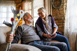 © NDABCREATIVITY - Happy bonding older married couple relaxing, laughing, enjoying leisure time together at home.