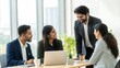 © Jo - Indian Professionals in Relaxed Team Discussion at Standing Desk
