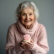 © Bagas - Happy elderly woman holding cupcake