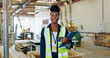 © DavidL2000/peopleimages.com - Portrait, woodwork and clipboard with black woman in factory for furniture, manufacturing or inspection. Lumber inventory, cabinetry construction and distribution warehouse with person and checklist