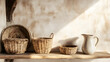 © SirArbusto - Rustic Still Life: A serene composition of handcrafted woven baskets and a pristine ceramic pitcher rests on a weathered wooden shelf against a textured wall, bathed in warm sunlight.