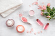 © 9dreamstudio - Homemade organic cosmetic with roses essential oil. Face cream with flowers and petals, top view