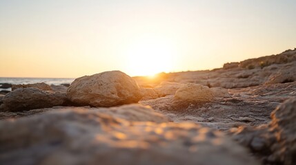 Poster - Golden sunset illuminates rocky seashore, large stones bathed in warm light, tranquil ocean view, peaceful coastal scene at dusk. : Generative AI