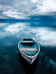 Aufkleber - A small, weathered blue rowboat sits serenely on a calm lake, its reflection mirroring the dramatic, cloudy sky above, creating a peaceful and contemplative scene. : Generative AI