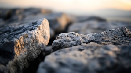 Poster - Close-up view of rough, grey stones at sunset, showcasing texture and natural light illuminating the rock surface.  The image evokes a sense of ruggedness and natural beauty. : Generative AI