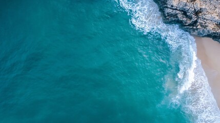 Poster - Aerial view of turquoise ocean waves breaking on a sandy beach next to rocky cliffs, creating a stunning coastal scene. : Generative AI