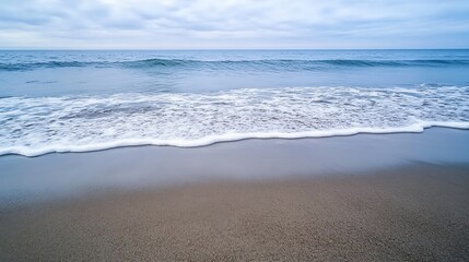 Poster - Serene coastal scene: gentle waves caress a tranquil sandy beach under a soft, cloudy sky, offering a peaceful and calming seascape. : Generative AI