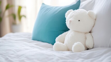 Aufkleber - White teddy bear sitting on a bed with a teal pillow, soft lighting and a blurred plant in the background, creating a calm and peaceful atmosphere. : Generative AI