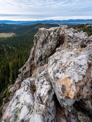 Poster - Majestic mountain vista: a panoramic view of a rocky outcrop overlooking a vast evergreen forest and distant blue mountain ranges under a partly cloudy sky. : Generative AI