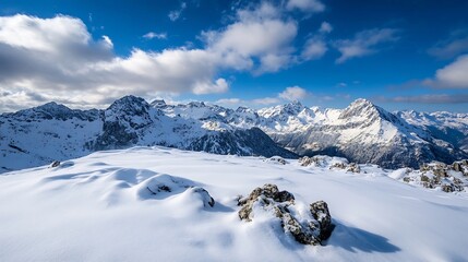 Aufkleber - Panoramic view of snow-covered mountain peaks under a vibrant blue sky with fluffy clouds, showcasing a pristine winter landscape. : Generative AI