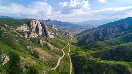 Aufkleber - Aerial view of a winding mountain road traversing a lush green valley, flanked by imposing rock formations under a partly cloudy sky. : Generative AI