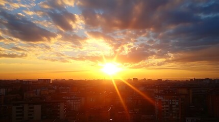 Aufkleber - Golden sunset rays illuminate a cityscape, casting a warm glow on residential buildings and creating a dramatic, vibrant sky filled with fluffy clouds. : Generative AI