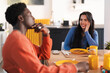 © Studio Marmellata - A young couple enjoys a pancake breakfast together at home. The woman smiles as the man listens thoughtfully during their morning conversation.