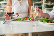 © Ladanifer - Senior couple having a healthy lunch with salads and wine at a restaurant