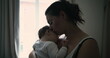 © Marco - Mother standing by window, cradling baby and gazing down with love and affection, capturing peaceful and intimate family moment at home
