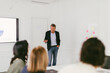 © Carlo Prearo - Mature businessman leading a presentation in modern office meeting room