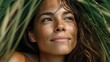 © liliyabatyrova - A woman relaxes in a swimsuit, embracing nature amidst vibrant tropical plants. Rays of sunlight filter through the greenery, illuminating her joyful expression