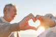 © Юлия Завалишина - Love heart shape peace. Senior older couple making heart shape with their hands. Adult mature old husband wife showing heart sign. Happy pensioner family. I love you happy valentines day