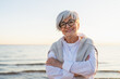© Юлия Завалишина - Outdoor portrait of confident stylish European middle aged senior woman. Older mature lady smiling on beach. Happy attractive senior female looking camera close up face headshot portrait. Happy people
