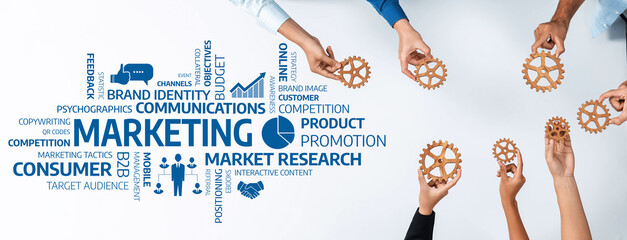 Fototapete - This image showcases hands holding gears above marketing concepts, emphasizing teamwork and strategic planning in brand promotion and market research activities. Amity