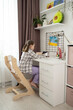 © ADDICTIVE STOCK - Cozy Child's Room with Playful Decor and Tablet Use
