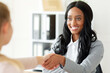 © Prostock-studio - Unrecognizable black HR manager shaking hands with female job appicant on employment interview at office. Portrait of headhunting specialist making deal with new employee