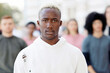 © Prostock-studio - Closeup portrait of black guy standing over multiracial group of young people protesting on the street. Young activists having strike against government politics, panorama