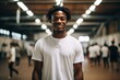 © Vorda Berge - Smiling portrait of a teenage male african american basketball player wearing a white t shirt in an indoor basketball gym