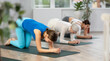 © JackF - Sportive women of different ages performing various stretching exercises during yoga workout together in gym studio