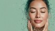 © Chandlerlikes - healthy hydrated face skin. skin care and moisturizing concept. asian woman with eyes closed and water splash around the face on light green background