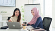 © snowing12 - Muslim Business Women Collaboration Asian Women Discussing Ideas on Laptop in Modern Office Diverse Teamwork Startup Success in Islamic Finance