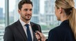 © Annada - Man in suit being interviewed by a woman with a microphone.