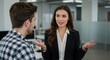 © Annada - Two people in an office setting are engaged in a conversation.