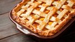 © Balaraw - Homemade peach pie with lattice crust on a wooden table.