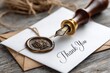 © SSP - Elegant thank you card with a wax seal and fountain pen resting on a rustic wooden table.