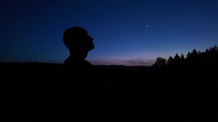 Wall Mural - silhouette of a man and countryside under the blue hour after sunset - before sunrise.