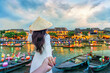 © tawatchai1990 - Women tourist holding man's hand and leading him to Hoi An ancient town,Hoi an city in Vietnam.
