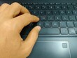 © Feb - Typing on Laptop Keyboard with Finger Pressing Keys