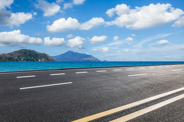 Wall Mural - empty asphalt road and blue sea with mountain natural landscape under blue sky