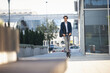 © Aleksandar - Businessman on e scooter in the city