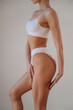 © standret - Woman is standing and posing. Close up view of sportive person that is in fitness clothes