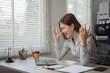 © MINAE - Young frustrated businesswoman working at office desk in front of laptop, she is stressed and disappointed with her work, having problems and feeling desperate