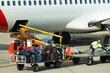 © Austockphoto - Loading baggage onto airplane