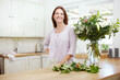 © peopleimages.com - Smile, portrait and woman with flowers for gift, bouquet and happiness with anniversary present. Floral, plants and mature lady with decoration, fragrance and arrangement at home or house counter