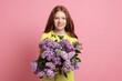 © New Africa - Portrait of smiling teenage girl with lilac flowers on pink background
